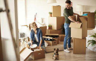 Young couple unpacking in new apartment, smiling and happy