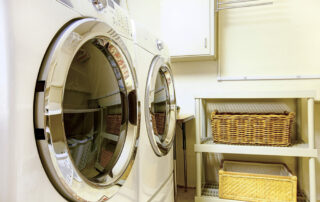 Close up of washer and dryer and shelves with organization in laundry room