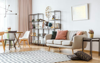 Open living room space with neutral colors, shelf in background