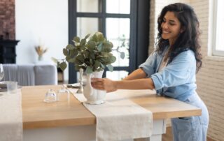 A woman decorating her Saint Joe apartments with a houseplant