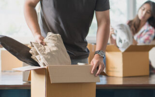 A young couple unpacks boxes at their new apartment in St. Joe, MO