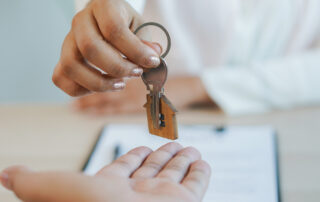 An apartment manager hands over keys to renter