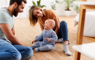 A young couple playing with the baby at the St. Joesph apartments